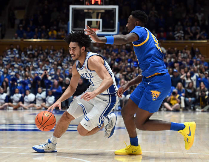 Duke Blue Devils guard Jared McCain dribbles past Pittsburgh Panthers defenders.